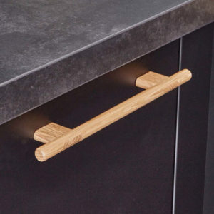 Holzgriff in einer schwarzen Küche.